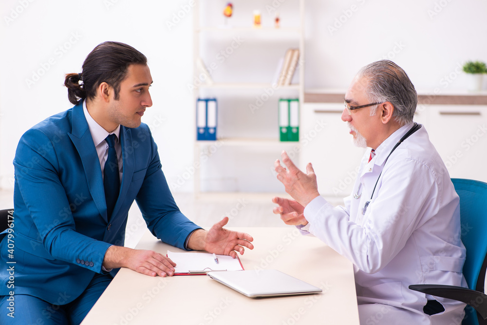 Young businessman meeting with old doctor Young businessman meeting with old doctor