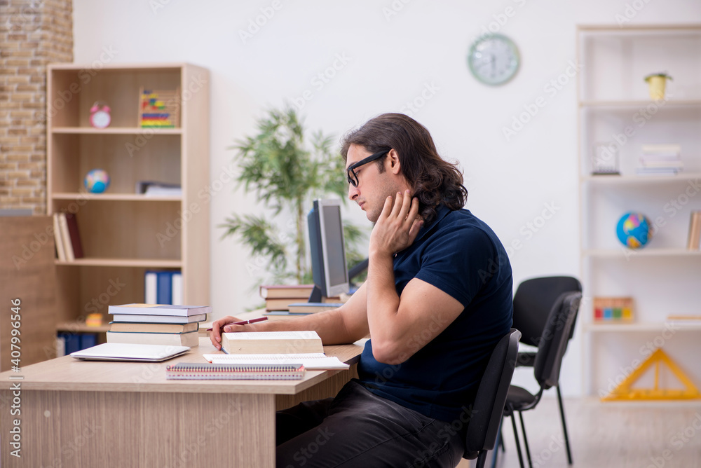 Young male student preparing for exams in the classroom Young male student preparing for exams in the classroom
