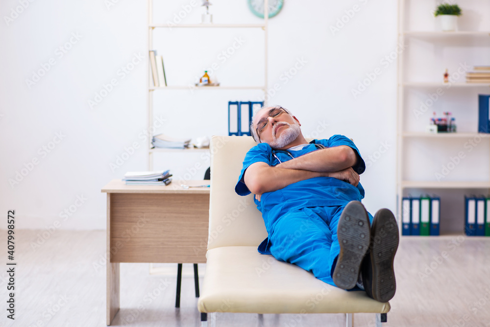 Old male doctor extremely tired after night shift Old male doctor extremely tired after night shift