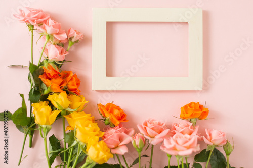 wooden photo frame next to bunch of roses