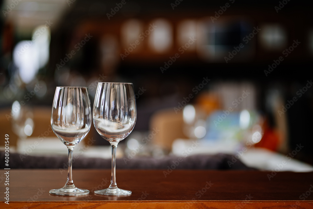 two empty clean wine glasses on a wooden table. utensils for alcoholic beverages. serving the table.