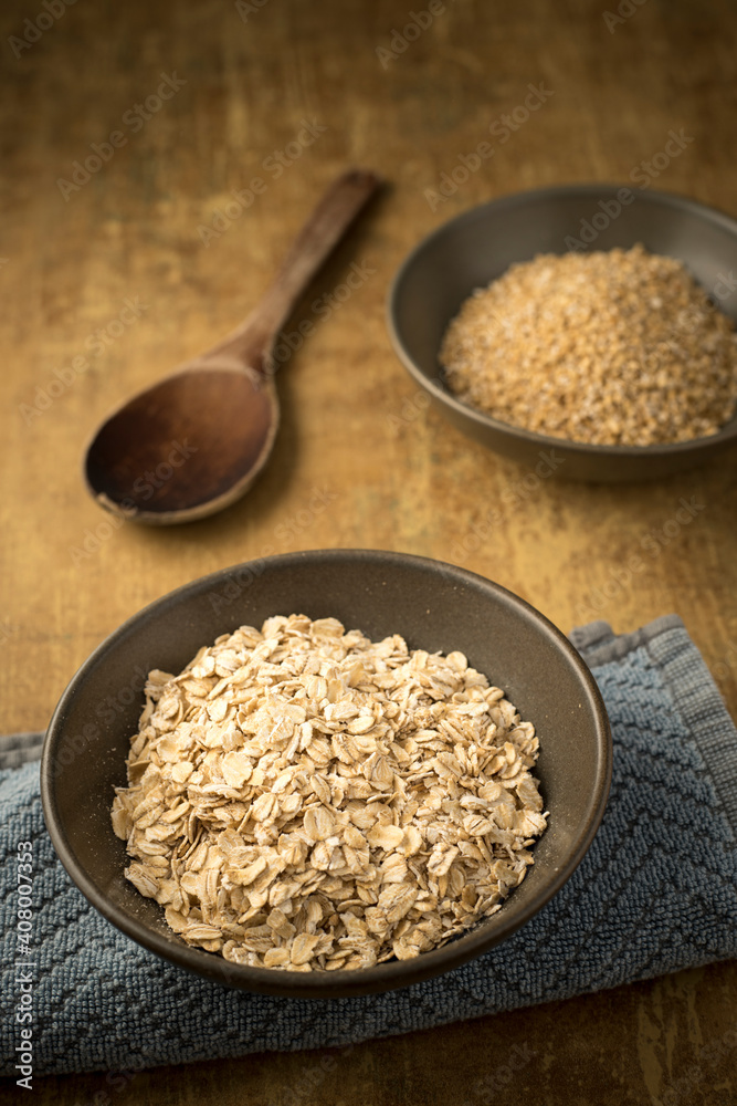 bowls of dried steel cut and rolled oats. bowls of dried steel cut and rolled oats.