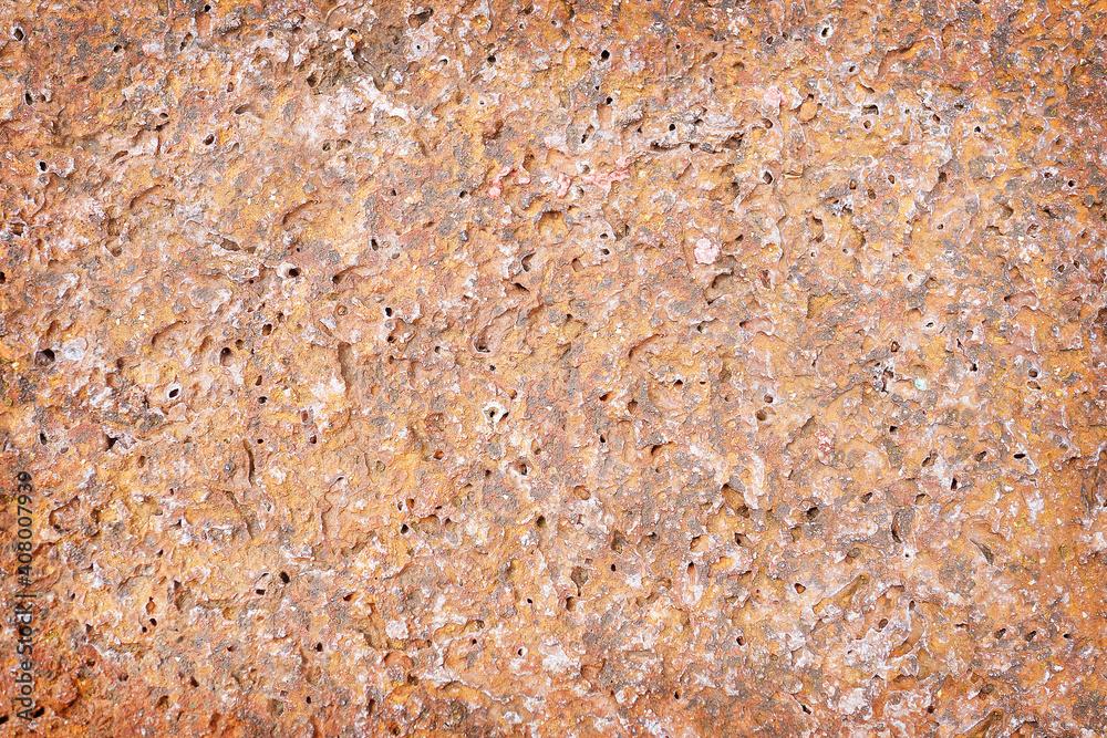 red stone rough with holes texture abstract background