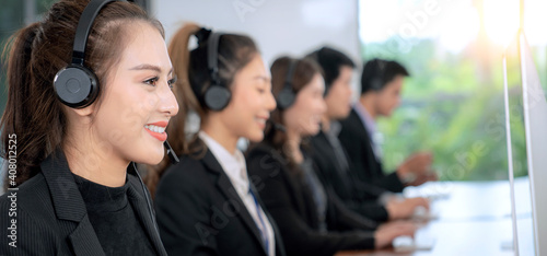 Positive Asian Female Customer Services Agent With Headset Working
