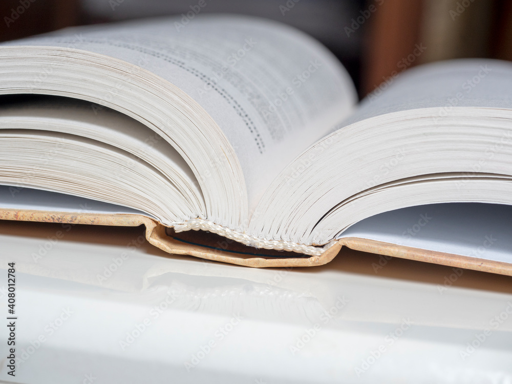 a thick open book lies on a white background. The concept of learning and knowledge a thick open book lies on a white background. The concept of learning and knowledge