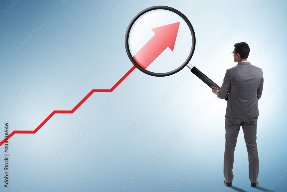Concept of economic growth with chart and magnifying glass Concept of economic growth with chart and magnifying glass