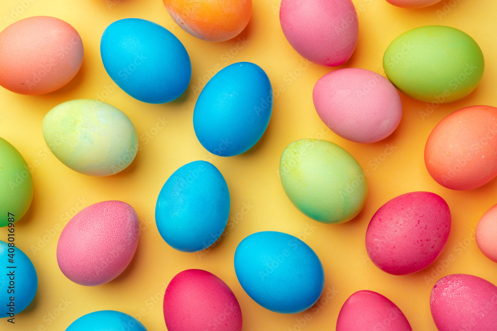 Painted Easter eggs on yellow background top view Painted Easter eggs on yellow background top view