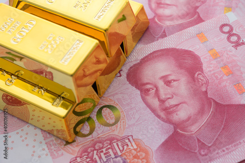 Photography Gold bars on Chinese yuan bill banknotes background
