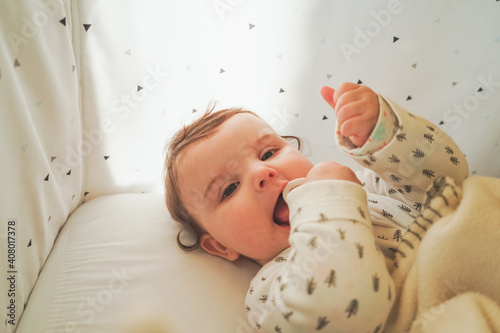 Wallpaper Mural Portrait of a little playful baby in her cradle Torontodigital.ca