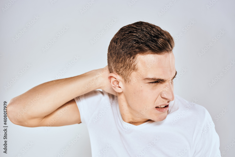 Man in white t-shirt displeased facial expression gesturing with hands studio lifestyle Man in white t-shirt displeased facial expression gesturing with hands studio lifestyle