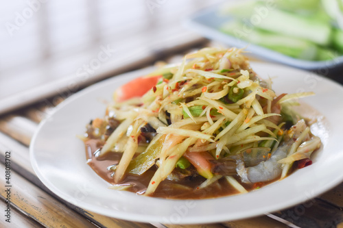 Papaya salad with shrimp in white dish. Thai food delicious and popular