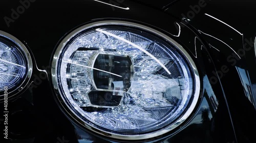 Luxury car front LED headlight with crystal effect. Closeup cinematic 4k shot.