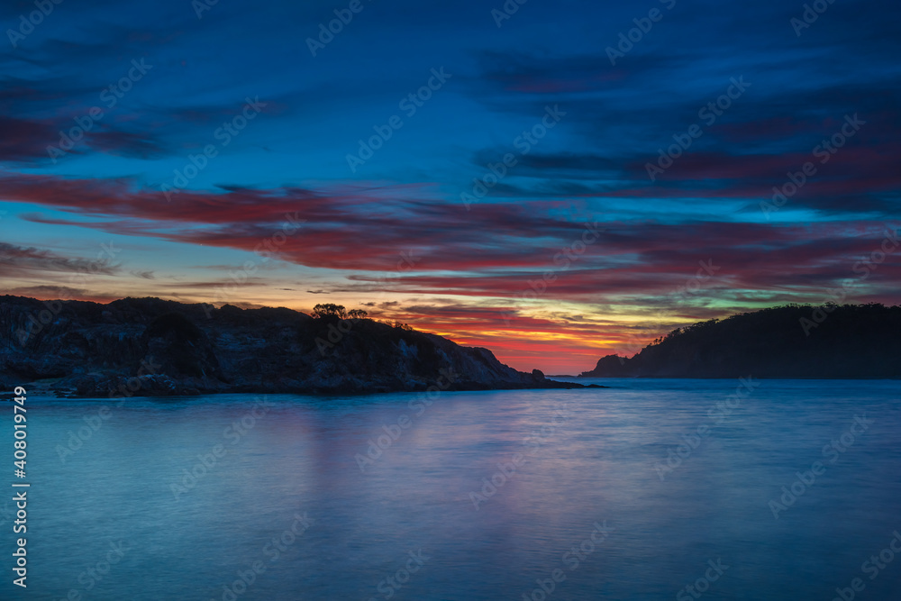 Blue Dawn with Pink Clouds and Rock Formations