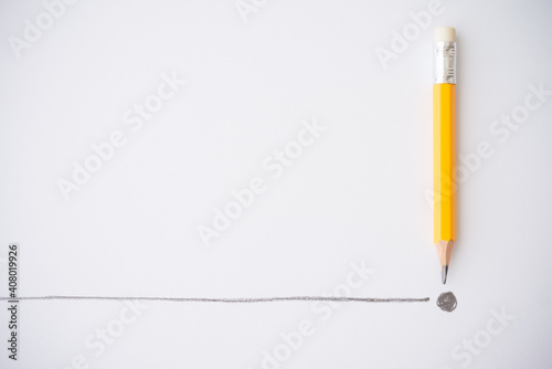 Flat lay of yellow colour pencil write line and end point on white paper background copy space. Business conclusion, creative idea, imagination and education concept.