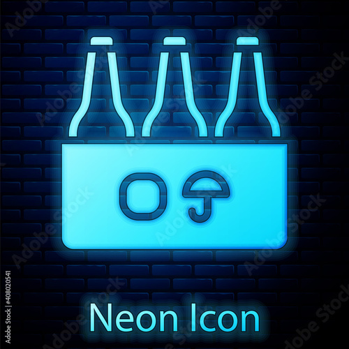Glowing neon Pack of beer bottles icon isolated on brick wall background. Case crate beer box sign. Vector.