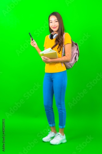 Portrait beautiful young student asian woman with book phone headphone and bag