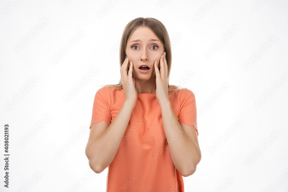 Worried and concerned blond girl is looking with frightened expression. Studio shot, white background Worried and concerned blond girl is looking with frightened expression. Studio shot, white background