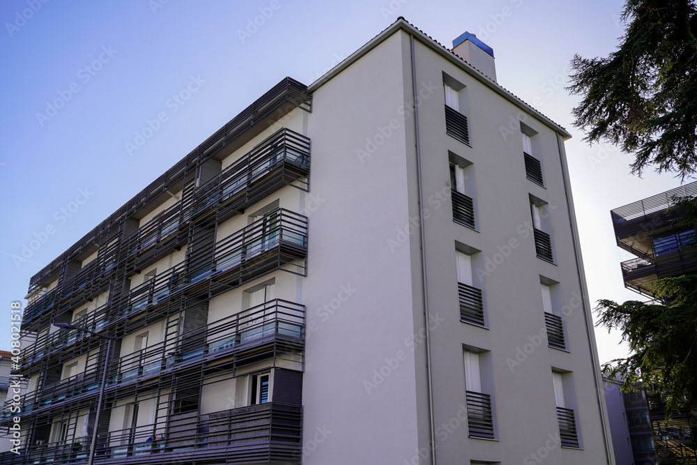 Facade of modern apartment building on a sunny day with a blue sky Facade of modern apartment building on a sunny day with a blue sky