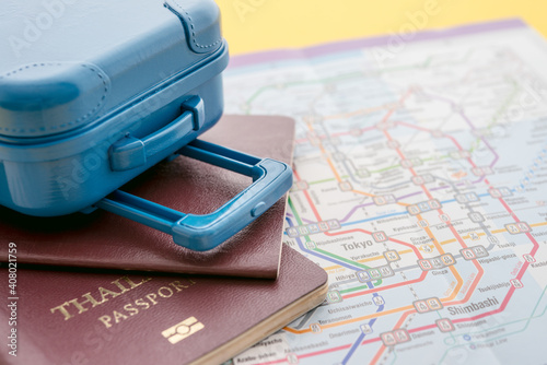 Suitcase and passport on map background. Travel insurance covers loss suitcase, flight delays, cancellations, evacuations and medical expenses. Travel insurance business concept.