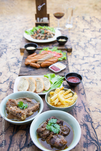 Beef and pork stew with French fries and others food recipes on wooden table, food meal preparing ready for eat concept