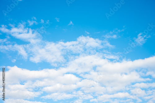 White clouds with blue sky background copy space. Sunshine day with beautiful clouds.