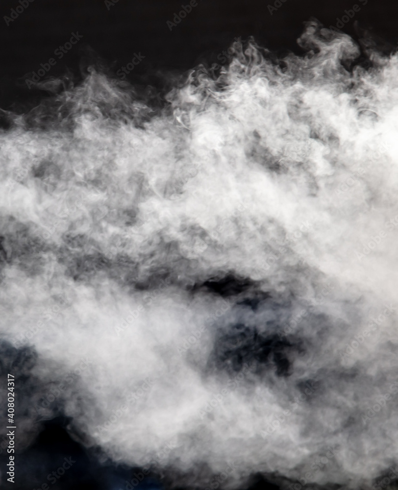 Fototapeta premium White smoke on a black background. Texture