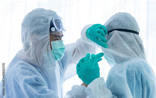 Couple scientists or doctors in protective suit relaxing and taking together in laboratory.