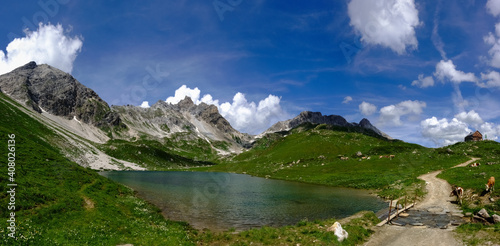 wonderful mountain valley with a lake and blue sky panorama