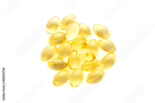 Fish oil gel capsules isolated on white background, top view. Pile of yellow fish oil capsules isolated on white background, top view. Omega-3 fish oil capsules. Close-up of yellow fish oil capsules.