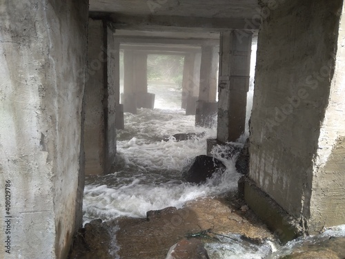 water flows down the waterfall in the basement of the dam flood accident