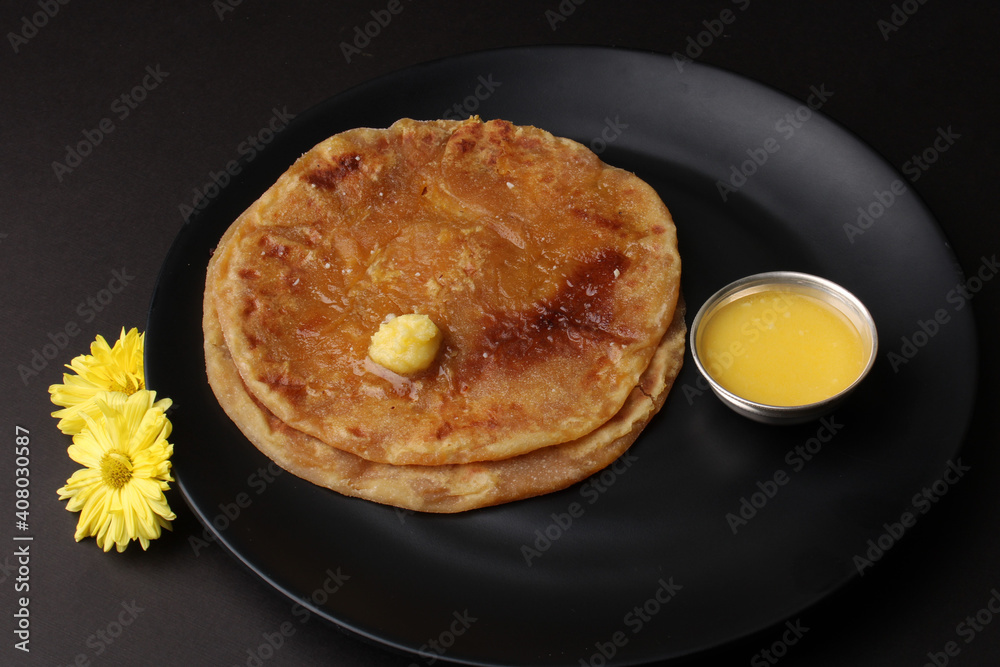 Puran Poli, also known as Holige, is an Indian sweet flatbread from India consumed mostly during Holi festival. Served in a plate with pure Ghee. Puran Poli, also known as Holige, is an Indian sweet flatbread from India consumed mostly during Holi festival. Served in a plate with pure Ghee.