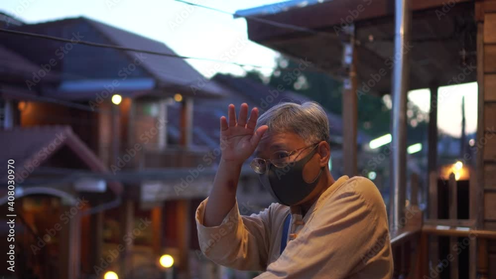 Portrait of Senior Asian putting protective medical facemask in New normal life wear face mask protection virus corona at outdoor when Changing everyday life from COVID-19 coronavirus outbreak