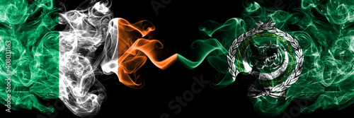 Fototapeta Naklejka Na Ścianę i Meble -  Republic of Ireland, Irish vs Arab League smoky mystic flags placed side by side. Thick colored silky abstract smoke flags.