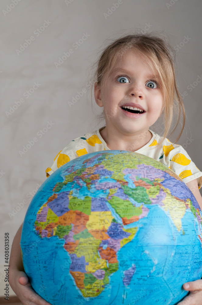 A girl holds a globe in her hand A girl holds a globe in her hand
