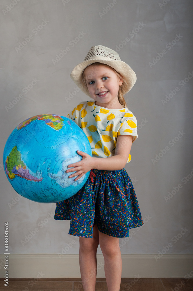 A girl holds a globe in her hand A girl holds a globe in her hand