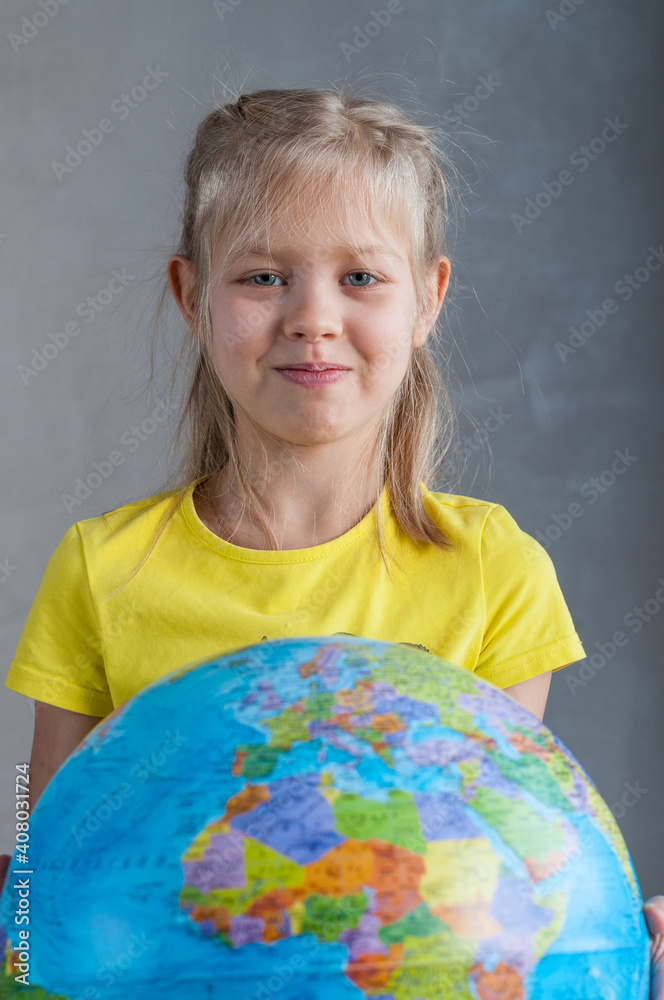 A girl holds a globe in her hand A girl holds a globe in her hand