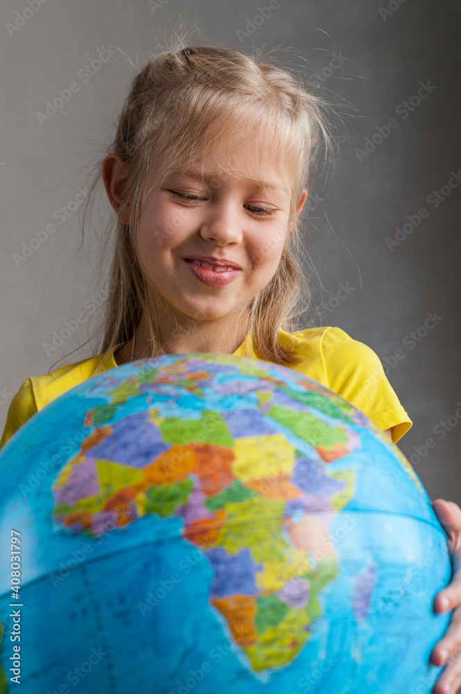 A girl holds a globe in her hand A girl holds a globe in her hand