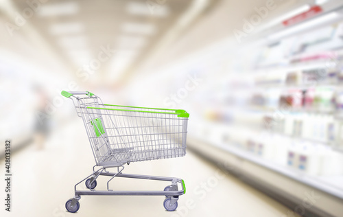 empty green shopping cart in supermarket aisle