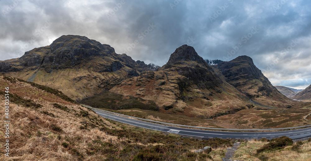 Majestic moody landscape image of Three Sisters in Glencoe in Scottish Highlands on a wet Winter day wit high water running down mountains Majestic moody landscape image of Three Sisters in Glencoe in Scottish Highlands on a wet Winter day wit high water running down mountains