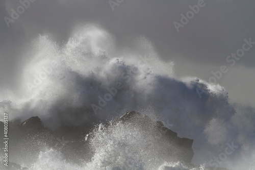 Wave breaking over cliff