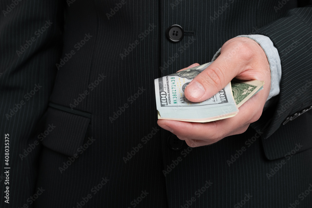 Man holding cash money in his hand closeup Man holding cash money in his hand closeup