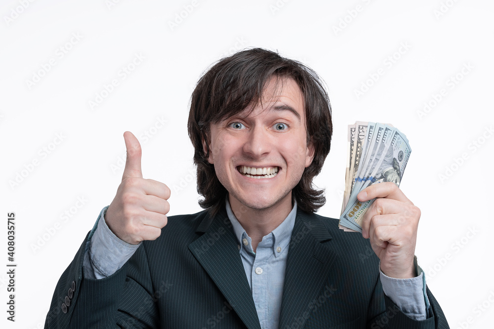 Smiling Lottery winner holding money and showing thumb up Smiling Lottery winner holding money and showing thumb up
