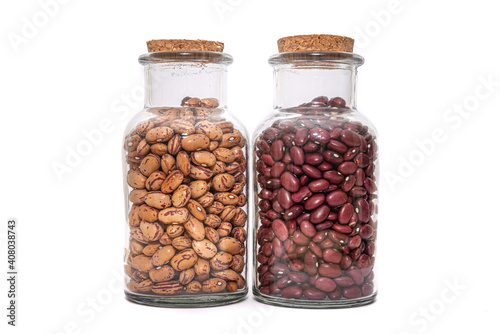Borlotti Beans And Kidney Bean dried and preserved in glass jars isolated on a white background. Healthy nutritional preserved ingredients.