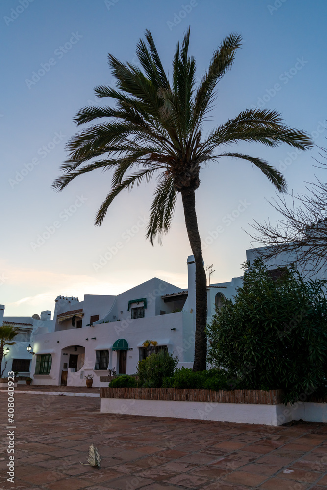 typical white Andalusian buildings in La Duquesa at sunset