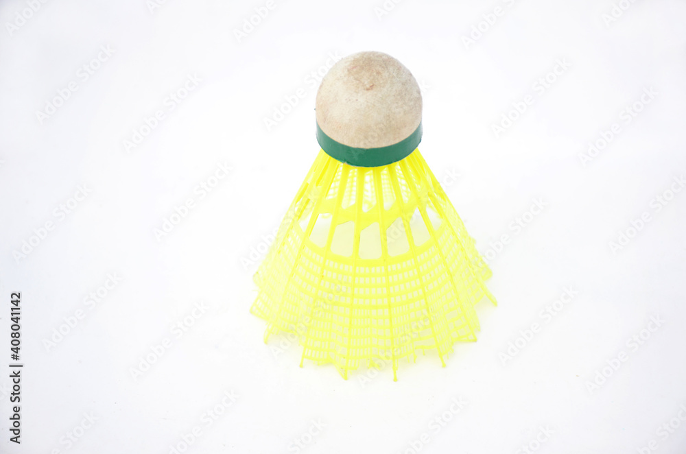 the old white yellow badminton shuttlecock isolated on white background.