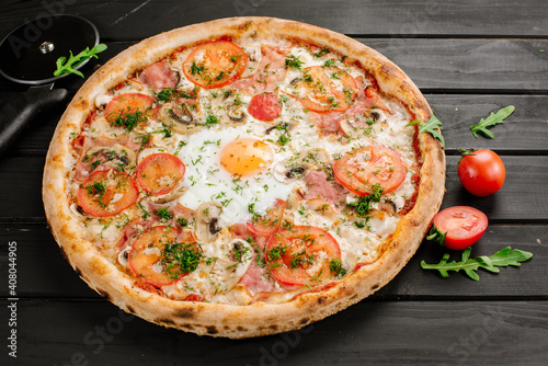 Fresh carbonara pizza with scrambled egg on wooden background