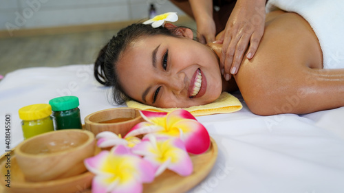 Spa Massage  Thai spa masseuse doing female massage in spa salon