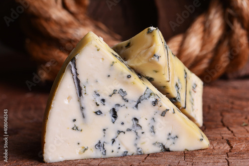 Fotografija Blue cheese on wood background