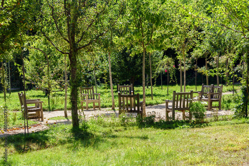 Chairs and apple trees in beautiful Albert Kahn Rose garden- Boulogne-Billancourt near Paris - France