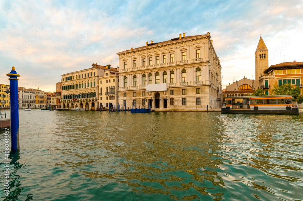 Beautiful panorama of the Grand Canal during a summer day with blue sky and clouds. In the background the Palazzo Grassi in the Venetian lagoon, Venice, Italy.
